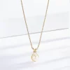 Gold necklace with a pear-shaped pearl pendant, highlighted by small sparkling stones around the pearl, resting on a smooth gold chain.