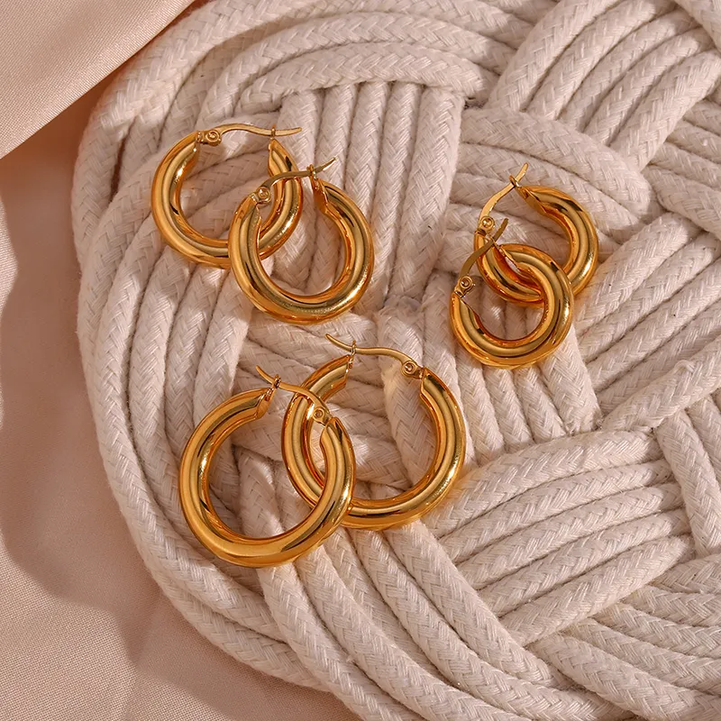 Gold hoop earrings set in various sizes, offering a stylish, durable design.