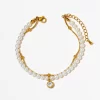 18K gold-plated pearl bracelet with a crystal pendant, displayed on a clean white background for a polished and elegant presentation.