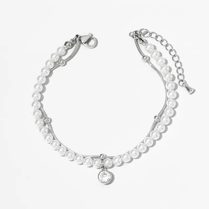 Stainless steel pearl bracelet with a crystal pendant, displayed on a clean white background for a sleek and elegant presentation.
