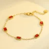 Gold bracelet with five rectangular red cubic zirconia stones set in a gold bezel, featuring a chain link design with a clasp closure.