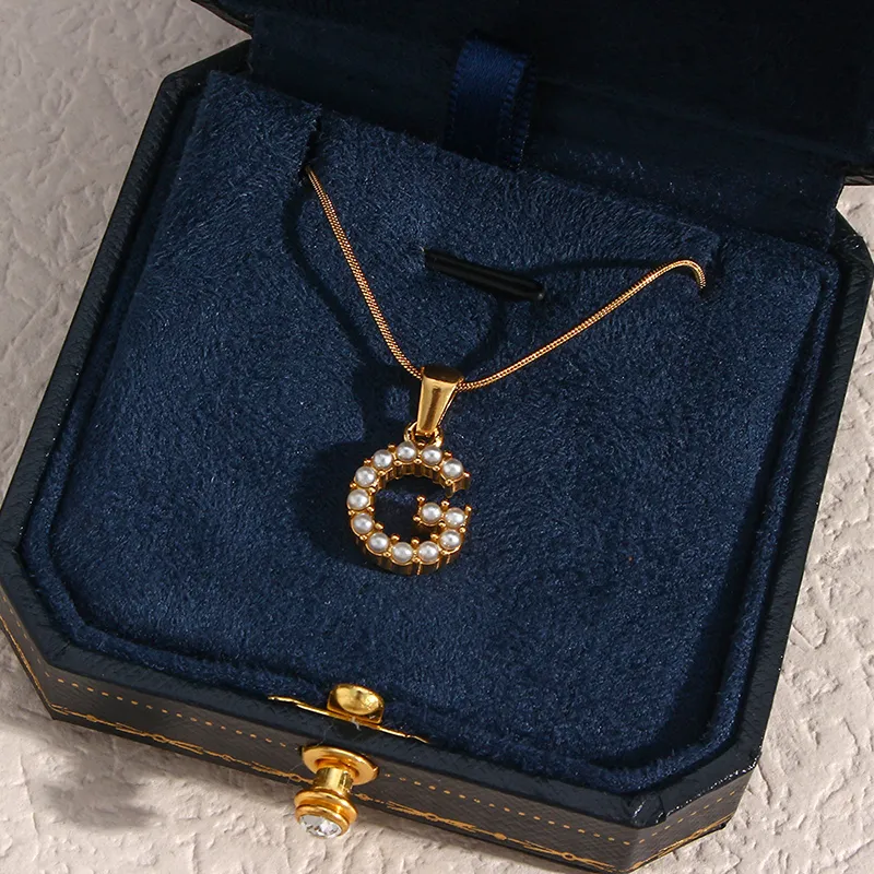 18K gold "G" initial pendant necklace with pearl accents, waterproof and durable.