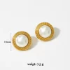 Gold earrings with large round pearls encircled by intricate gold detailing.
