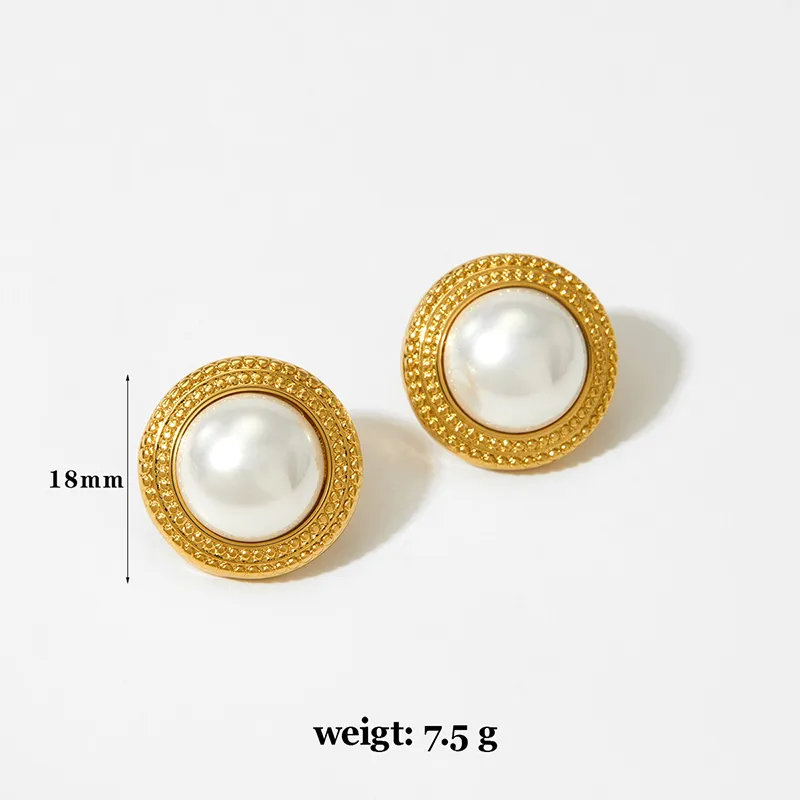 Gold earrings with large round pearls encircled by intricate gold detailing.