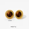 Gold earrings featuring a round tiger eye stone surrounded by gold beading.
