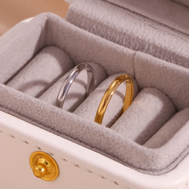 Gold and silver rings placed in a velvet jewelry box, showcasing modern elegance.
