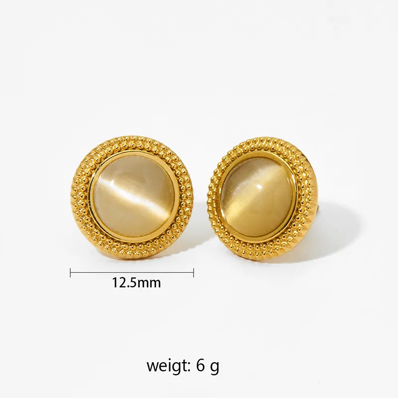 Gold earrings with round cat's eye stones framed by gold beading.