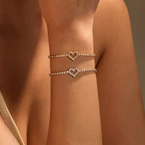 Heart-shaped crystal bracelets in gold and silver, designed to be waterproof and fade-resistant for lasting elegance.