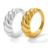 Silver and gold chunky twist rings displayed side by side, showcasing their polished finish and bold, twisted design.