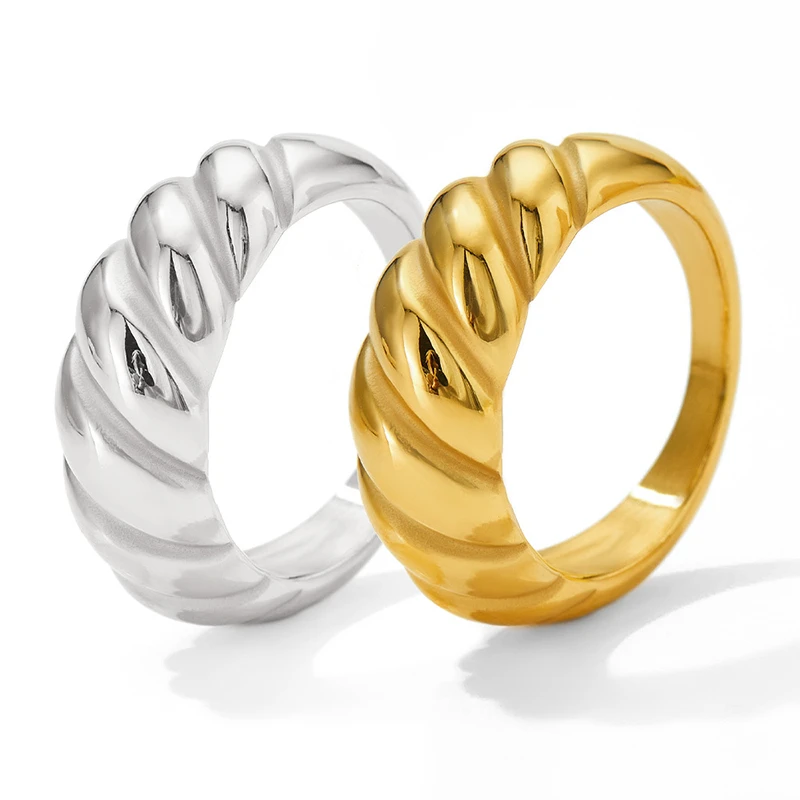 Silver and gold chunky twist rings displayed side by side, showcasing their polished finish and bold, twisted design.