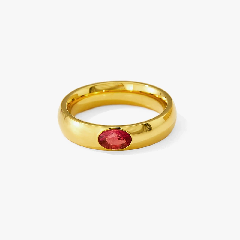 Gold ring with oval red cubic zirconia stone.