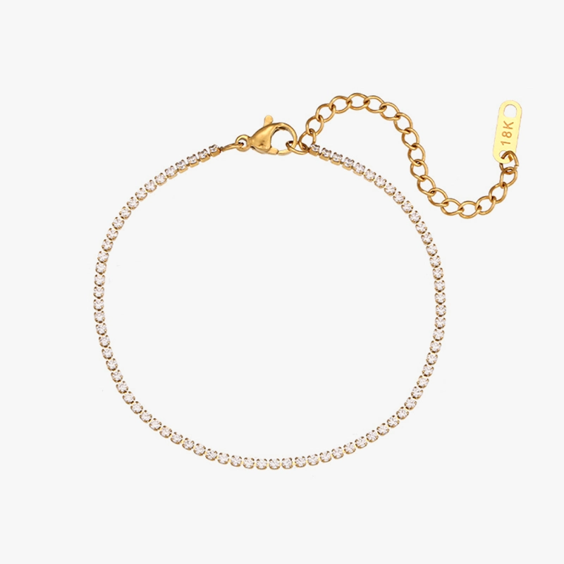 18K gold-plated stainless steel tennis bracelet with cubic zirconia stones and an adjustable chain closure, displayed against a white background.