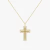 Gold cross pendant necklace set with cubic zirconia crystals, hanging from a fine chain against a white background.