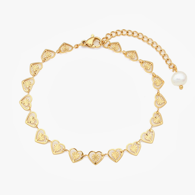 18K gold-plated heart chain bracelet with engraved heart details, an adjustable extension chain, and a pearl accent, displayed on a white background.
