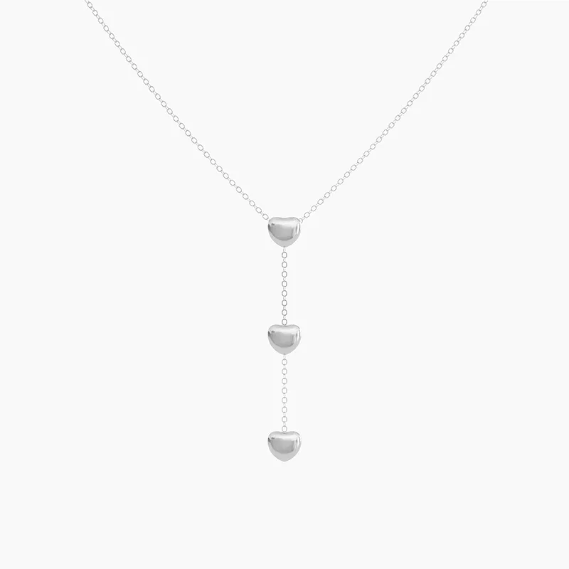 Stainless steel necklace with three heart pendants on a delicate chain, waterproof and tarnish-resistant.