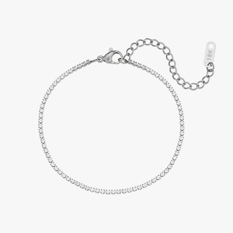 Minimalist stainless steel tennis bracelet with sparkling cubic zirconia stones and an adjustable chain closure, displayed against a white background.