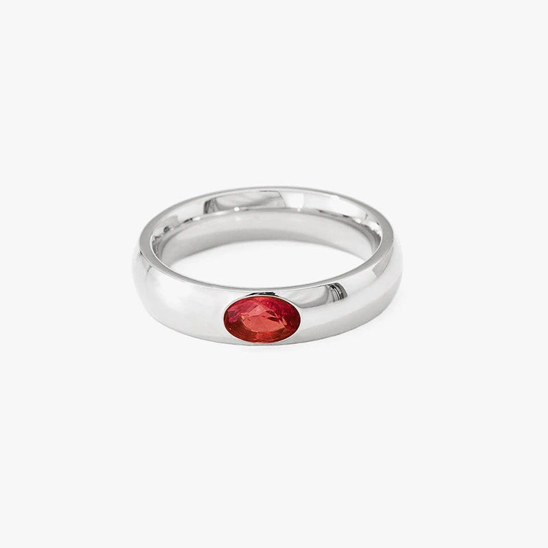 Silver ring with oval red cubic zirconia stone.