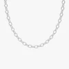 A close-up of a silver Cuban link chain necklace against a white background, showcasing its modern and bold design.