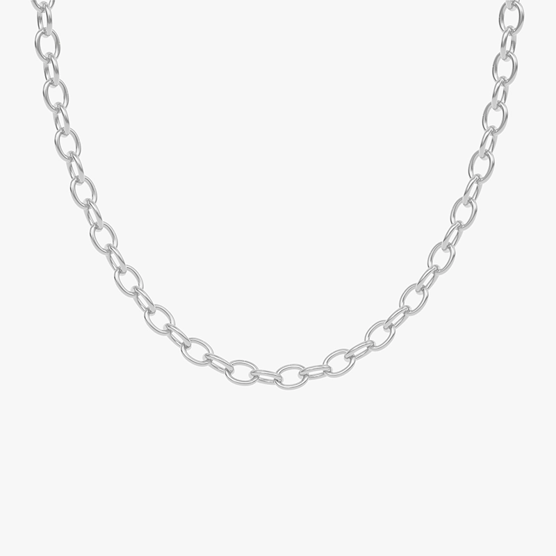 A close-up of a silver Cuban link chain necklace against a white background, showcasing its modern and bold design.