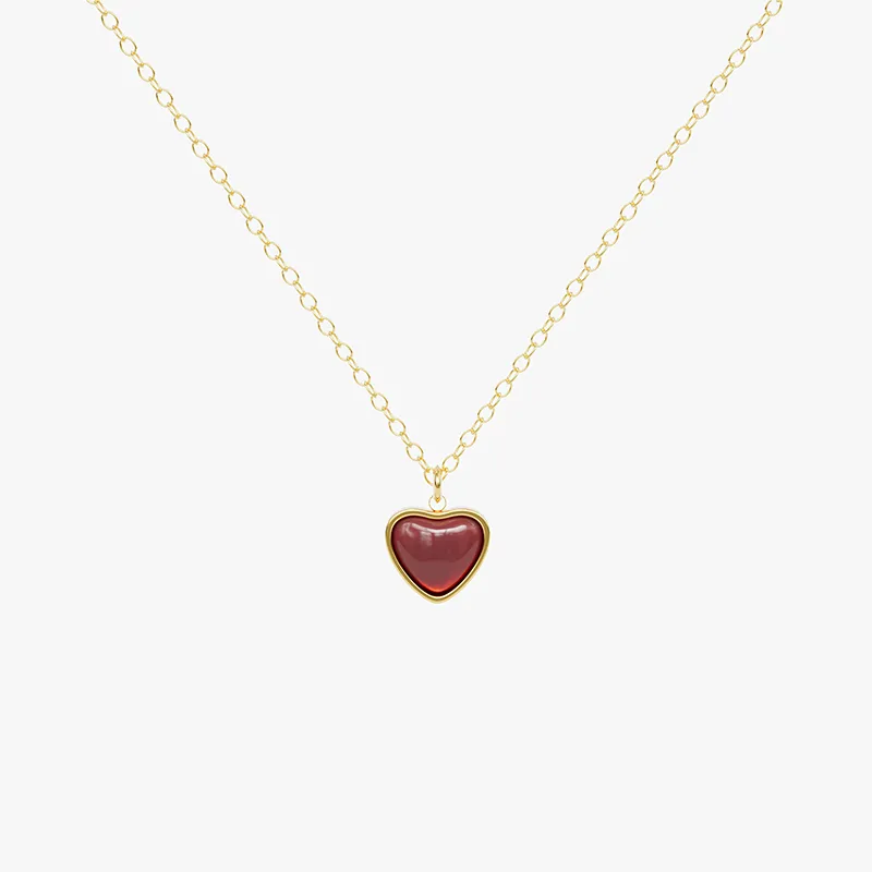 18K gold necklace with a heart-shaped red agate pendant, featuring a delicate chain and a timeless design.