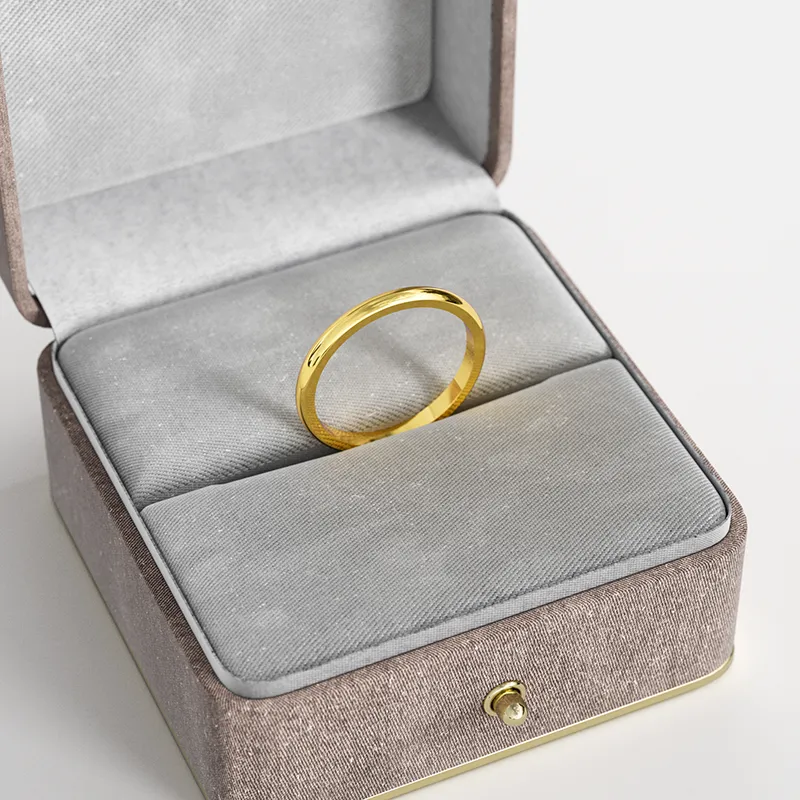 A simple 18K gold-plated band ring, elegantly displayed in a gray velvet jewelry box, emphasizing its minimalist and timeless design.