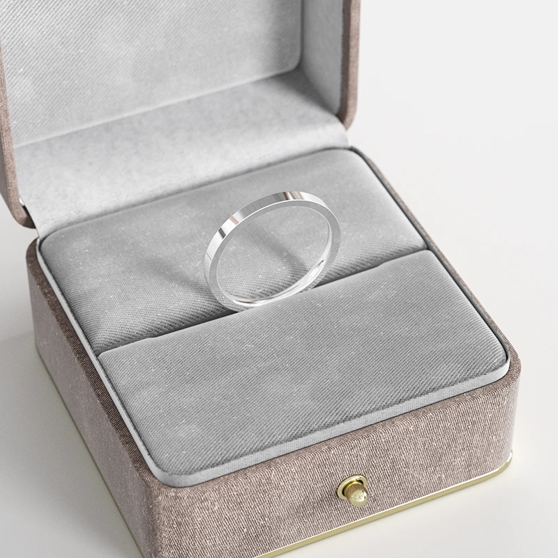 A stainless steel flat-edge band ring, elegantly displayed in a gray velvet jewelry box, highlighting its sleek and modern design.