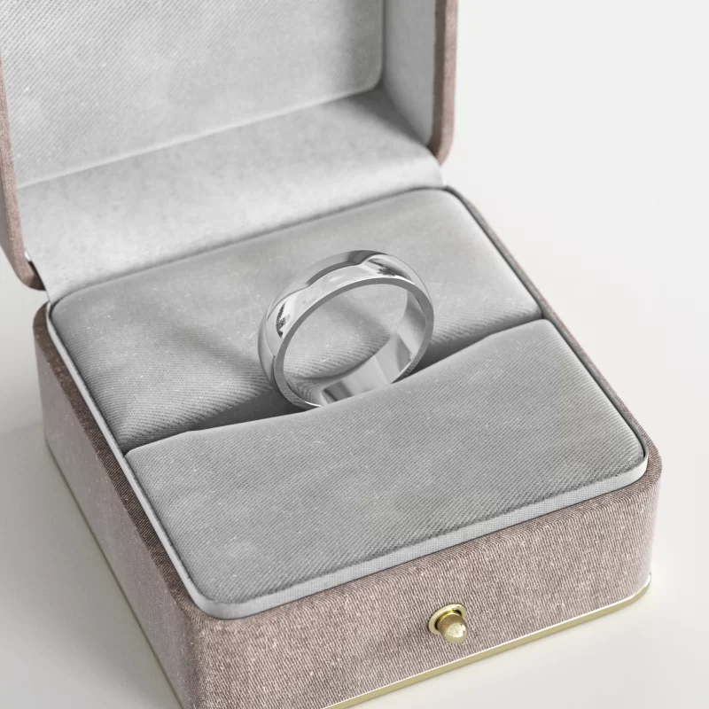 A stainless steel wide band ring with a polished finish, elegantly displayed in a gray velvet jewelry box, showcasing its sleek and modern design.
